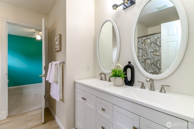 3112 87th Avenue Ct E, Edgewood, WA 98371 - bathroom with wood finished floors, double vanity, and a ceiling fan