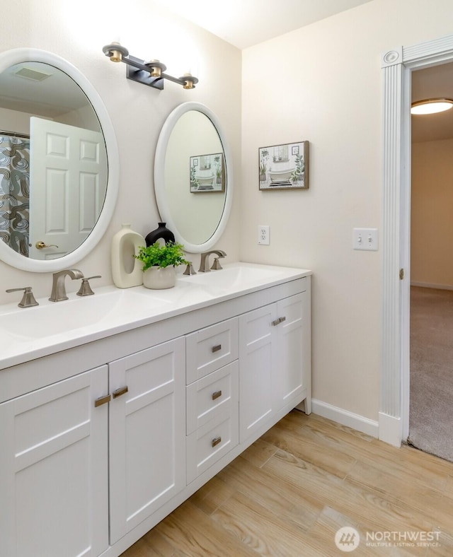 3112 87th Avenue Ct E, Edgewood, WA 98371 - bathroom featuring double vanity and wood finished floors
