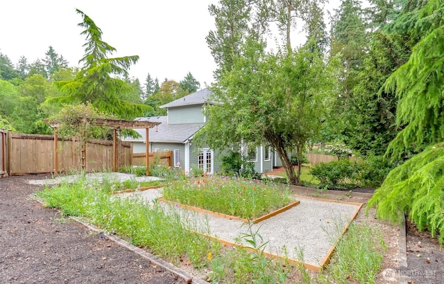 3112 87th Avenue Ct E, Edgewood, WA 98371 - fenced backyard with a vegetable garden and a pergola