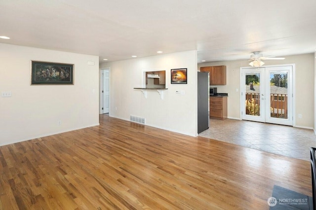 16204 Corliss Pl N, Shoreline, WA 98133 - unfurnished living room featuring light wood-style floors, recessed lighting, a ceiling fan, and french doors
