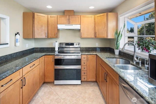 16204 Corliss Pl N, Shoreline, WA 98133 - kitchen featuring appliances with stainless steel finishes, under cabinet range hood, dark stone counters, light tile patterned floors, and recessed lighting