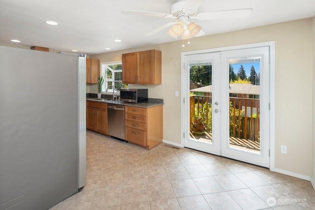 16204 Corliss Pl N, Shoreline, WA 98133 - kitchen featuring appliances with stainless steel finishes, brown cabinets, ceiling fan, french doors, and dark countertops