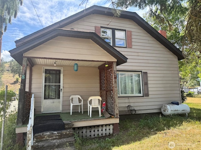 8 S Main St, Curlew, WA 99118 - view of front facade featuring a porch and a chimney