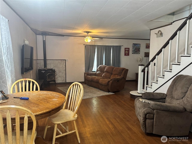 8 S Main St, Curlew, WA 99118 - dining room featuring wood finished floors, a wood stove, a ceiling fan, and stairway