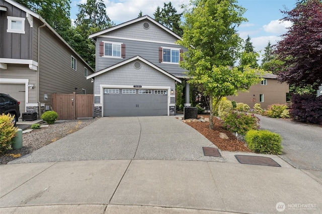 7608 16th Pl SE, Lake Stevens, WA 98258 - view of front of house featuring concrete driveway, stone siding, and an attached garage