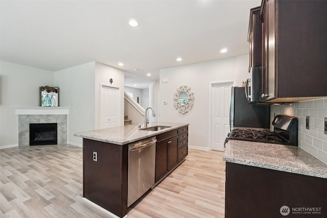 7608 16th Pl SE, Lake Stevens, WA 98258 - kitchen with stainless steel dishwasher, gas range, light wood-type flooring, dark brown cabinetry, and recessed lighting