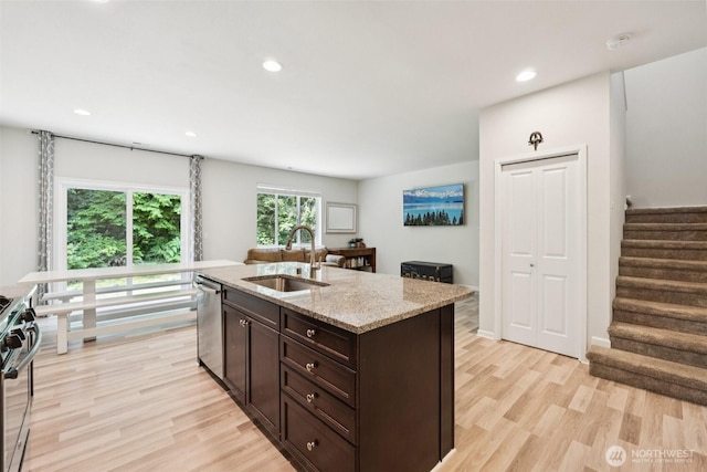 7608 16th Pl SE, Lake Stevens, WA 98258 - kitchen with appliances with stainless steel finishes, light wood-style floors, dark brown cabinetry, light stone countertops, and recessed lighting