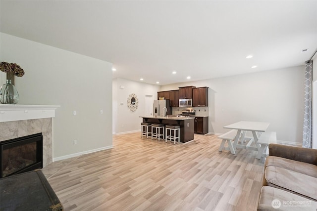 7608 16th Pl SE, Lake Stevens, WA 98258 - living room with recessed lighting, light wood-type flooring, and a fireplace