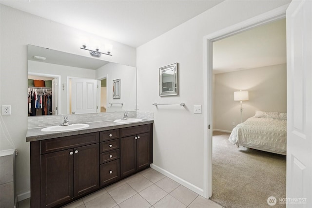 7608 16th Pl SE, Lake Stevens, WA 98258 - bathroom featuring double vanity, tile patterned flooring, and a walk in closet