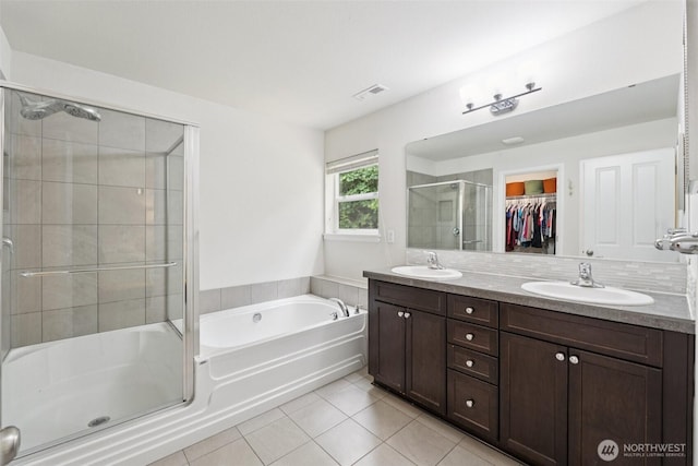 7608 16th Pl SE, Lake Stevens, WA 98258 - bathroom featuring tile patterned flooring, a stall shower, double vanity, a bath, and a spacious closet