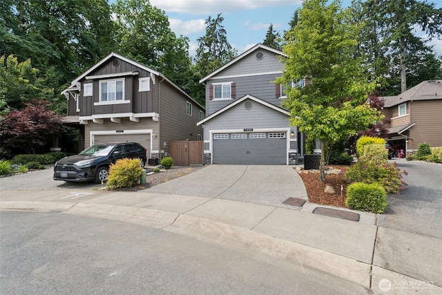 7608 16th Pl SE, Lake Stevens, WA 98258 - view of front of property with driveway, stone siding, board and batten siding, and an attached garage