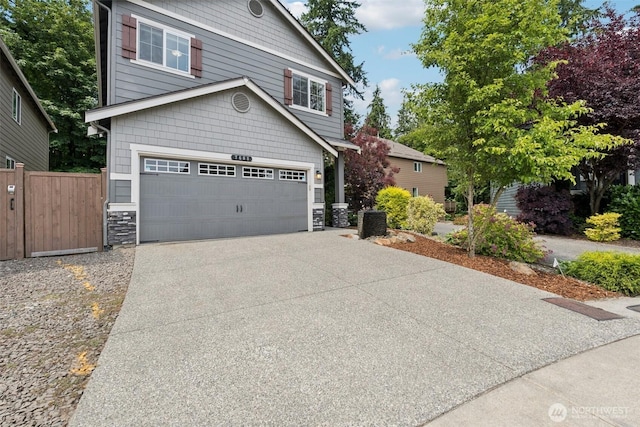 7608 16th Pl SE, Lake Stevens, WA 98258 - view of front of house featuring driveway, a garage, and stone siding