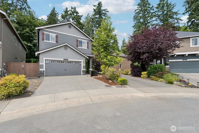 7608 16th Pl SE, Lake Stevens, WA 98258 - view of front of property featuring concrete driveway, stone siding, and a garage