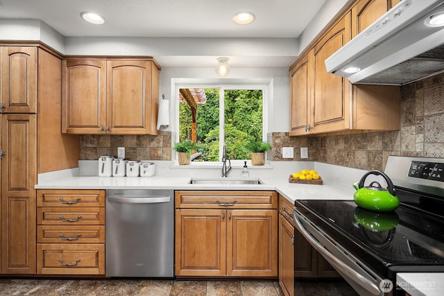 409 169th St SE, Bothell, WA 98012 - kitchen with appliances with stainless steel finishes, range hood, light countertops, backsplash, and brown cabinets