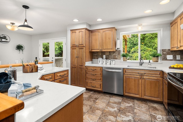 409 169th St SE, Bothell, WA 98012 - kitchen featuring stainless steel dishwasher, plenty of natural light, stove, light countertops, and recessed lighting