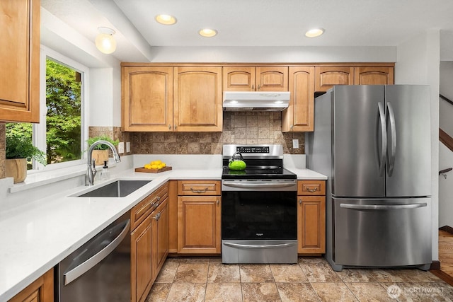 409 169th St SE, Bothell, WA 98012 - kitchen featuring appliances with stainless steel finishes, under cabinet range hood, decorative backsplash, light countertops, and recessed lighting