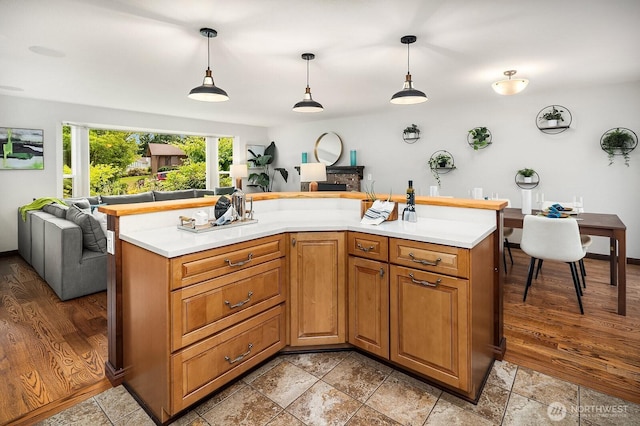 409 169th St SE, Bothell, WA 98012 - kitchen with open floor plan, light countertops, hanging light fixtures, and brown cabinetry