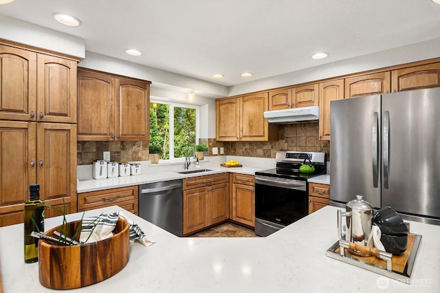 409 169th St SE, Bothell, WA 98012 - kitchen featuring appliances with stainless steel finishes, under cabinet range hood, backsplash, light countertops, and recessed lighting