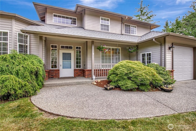 21414 137th Ave NE, Arlington, WA 98223 - view of front of property with covered porch, a garage, brick siding, and roof with shingles