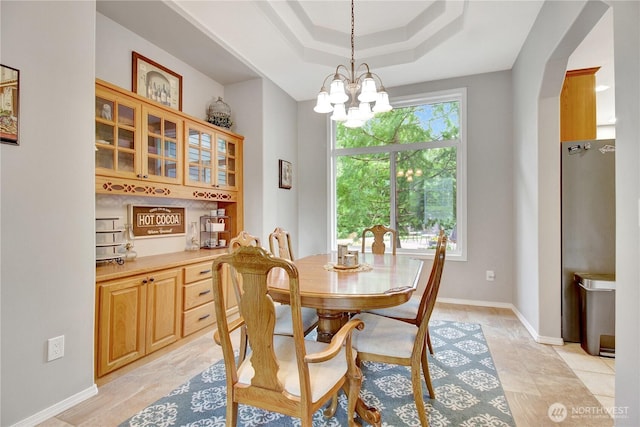 21414 137th Ave NE, Arlington, WA 98223 - dining space featuring a chandelier, a tray ceiling, and arched walkways