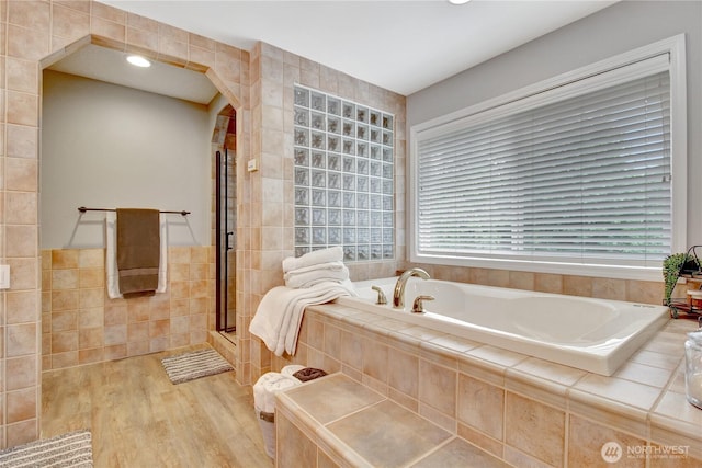 21414 137th Ave NE, Arlington, WA 98223 - full bath with tile walls, a garden tub, wood finished floors, a shower with shower door, and recessed lighting