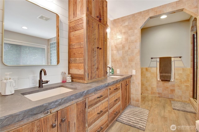 21414 137th Ave NE, Arlington, WA 98223 - full bathroom featuring tile walls, double vanity, wood finished floors, and recessed lighting