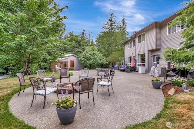 21414 137th Ave NE, Arlington, WA 98223 - view of patio with an outdoor fire pit and an outbuilding