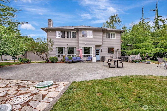 21414 137th Ave NE, Arlington, WA 98223 - back of house with an outdoor hangout area, a chimney, a patio area, and a lawn