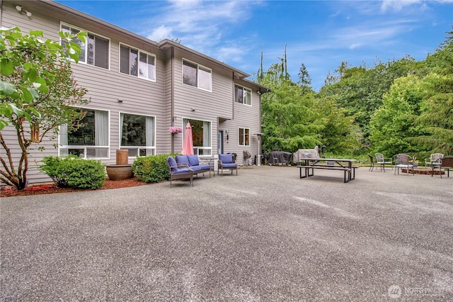 21414 137th Ave NE, Arlington, WA 98223 - back of house featuring a patio and an outdoor living space with a fire pit