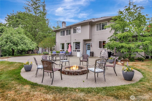 21414 137th Ave NE, Arlington, WA 98223 - rear view of property with a chimney, an outdoor fire pit, a patio, and a lawn