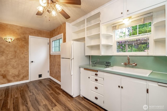 6711 100th St SW, Lakewood, WA 98499 - kitchen featuring freestanding refrigerator, open shelves, a ceiling fan, dark wood-type flooring, and white cabinetry