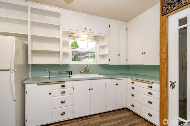 6711 100th St SW, Lakewood, WA 98499 - kitchen featuring freestanding refrigerator, open shelves, white cabinets, ornamental molding, and light countertops