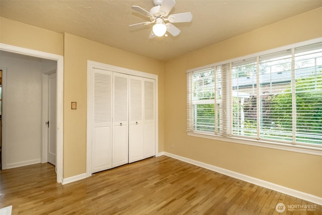6711 100th St SW, Lakewood, WA 98499 - unfurnished bedroom featuring light wood finished floors, a closet, and ceiling fan