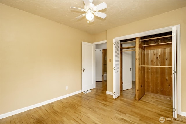 6711 100th St SW, Lakewood, WA 98499 - unfurnished bedroom with light wood-style flooring, a closet, and ceiling fan