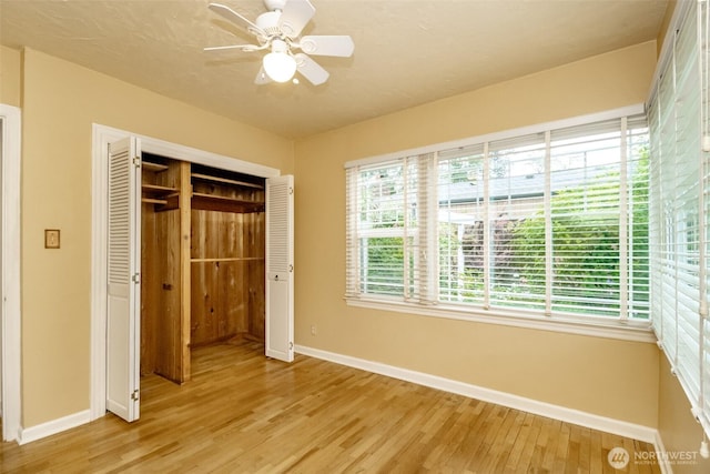 6711 100th St SW, Lakewood, WA 98499 - unfurnished bedroom with light wood-style flooring, a closet, and ceiling fan