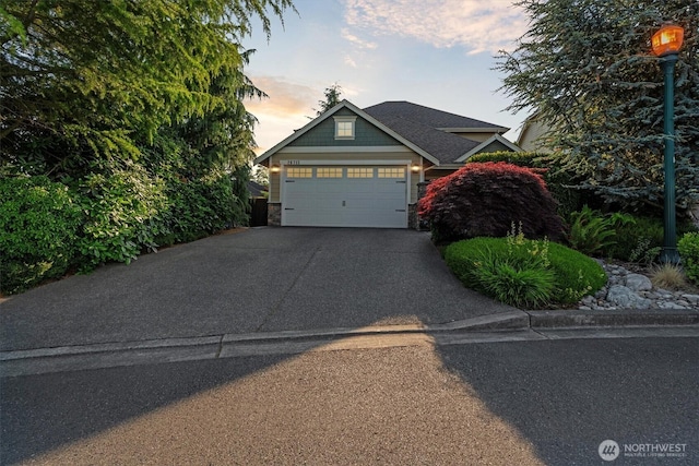 26713 178th Loop SE, Covington, WA 98042 - craftsman-style home with concrete driveway, an attached garage, and stone siding