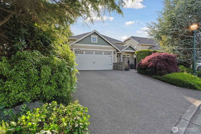 26713 178th Loop SE, Covington, WA 98042 - craftsman house with driveway, stone siding, an attached garage, and a gate