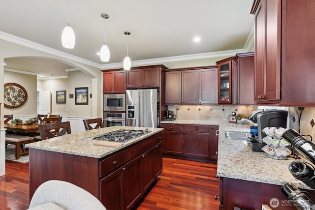 26713 178th Loop SE, Covington, WA 98042 - kitchen with stainless steel appliances, arched walkways, dark wood-type flooring, light stone counters, and backsplash