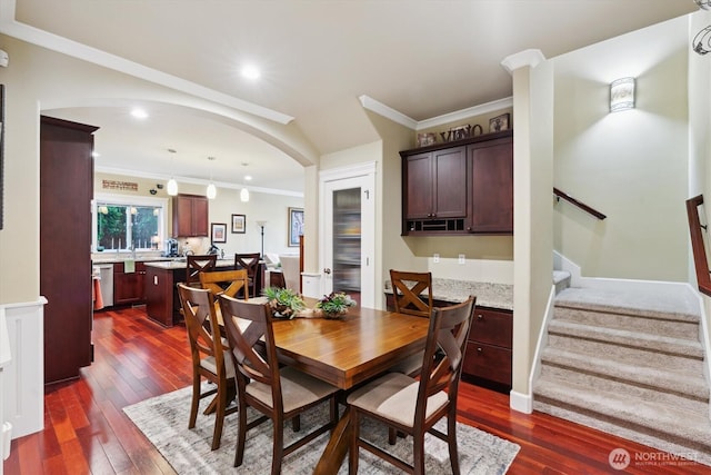 26713 178th Loop SE, Covington, WA 98042 - dining area featuring arched walkways, dark wood finished floors, ornamental molding, stairway, and recessed lighting