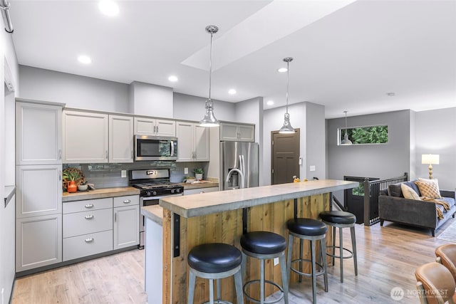 3 River Ridge Loop, Bellingham, WA 98229 - kitchen featuring stainless steel appliances, gray cabinets, light wood-type flooring, light countertops, and tasteful backsplash