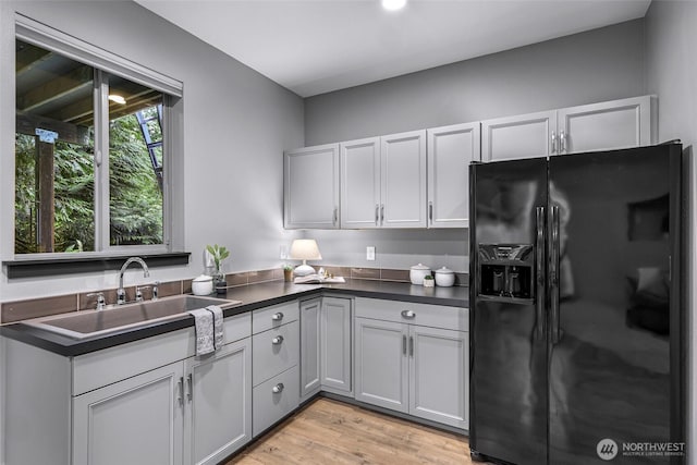 3 River Ridge Loop, Bellingham, WA 98229 - kitchen featuring black refrigerator with ice dispenser, dark countertops, and light wood finished floors