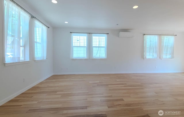 18768 1st Ave NE, Suquamish, WA 98392 - empty room featuring a wall mounted AC, light wood-style floors, and recessed lighting