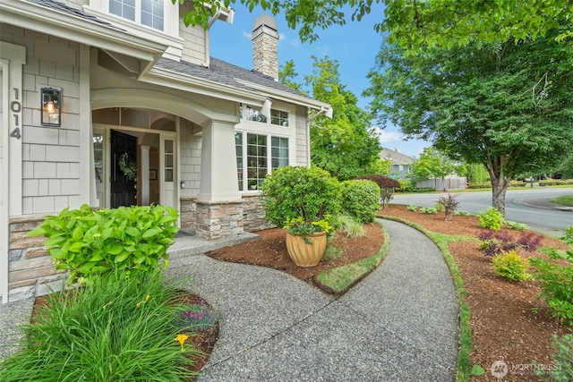 1014 274th Way SE, Sammamish, WA 98075 - entrance to property featuring stone siding, a shingled roof, and a chimney