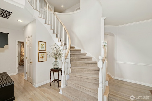 1014 274th Way SE, Sammamish, WA 98075 - stairway featuring wood finished floors, arched walkways, crown molding, and recessed lighting