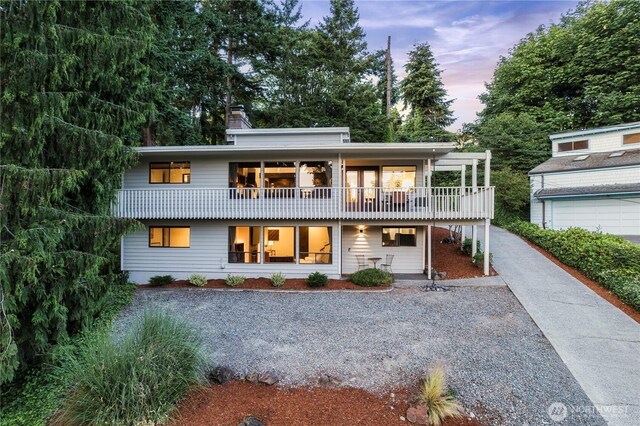 830 S 301st Pl, Federal Way, WA 98003 - view of front of property with a balcony, a chimney, covered porch, and driveway