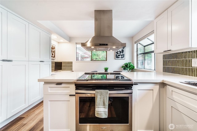 830 S 301st Pl, Federal Way, WA 98003 - kitchen featuring stainless steel electric range oven, island range hood, white cabinets, light countertops, and recessed lighting