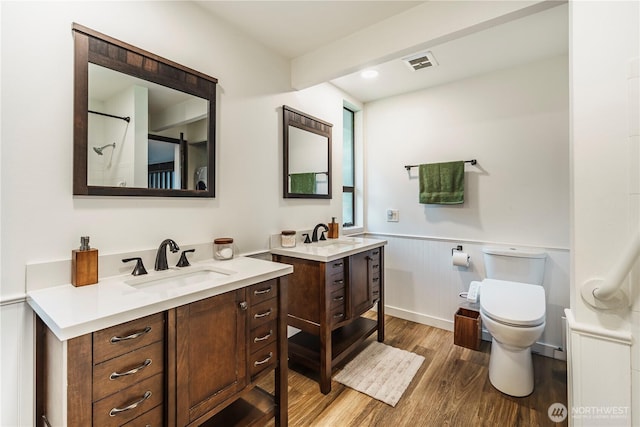 830 S 301st Pl, Federal Way, WA 98003 - bathroom with wood finished floors, a wainscoted wall, and two vanities