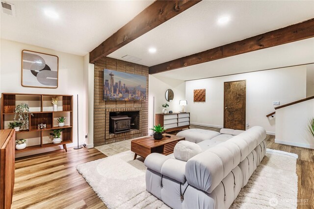 830 S 301st Pl, Federal Way, WA 98003 - living room with beam ceiling, wood finished floors, a wood stove, and recessed lighting
