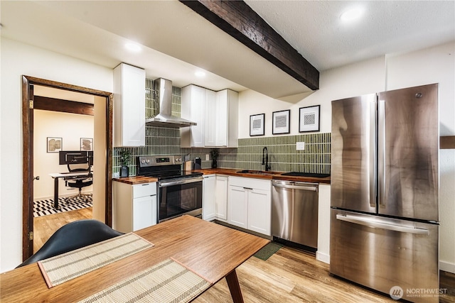 830 S 301st Pl, Federal Way, WA 98003 - kitchen with stainless steel appliances, butcher block counters, wall chimney range hood, beamed ceiling, and white cabinetry