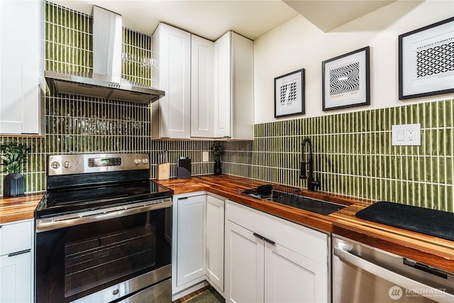 830 S 301st Pl, Federal Way, WA 98003 - kitchen featuring butcher block countertops, stainless steel appliances, wall chimney range hood, and white cabinetry